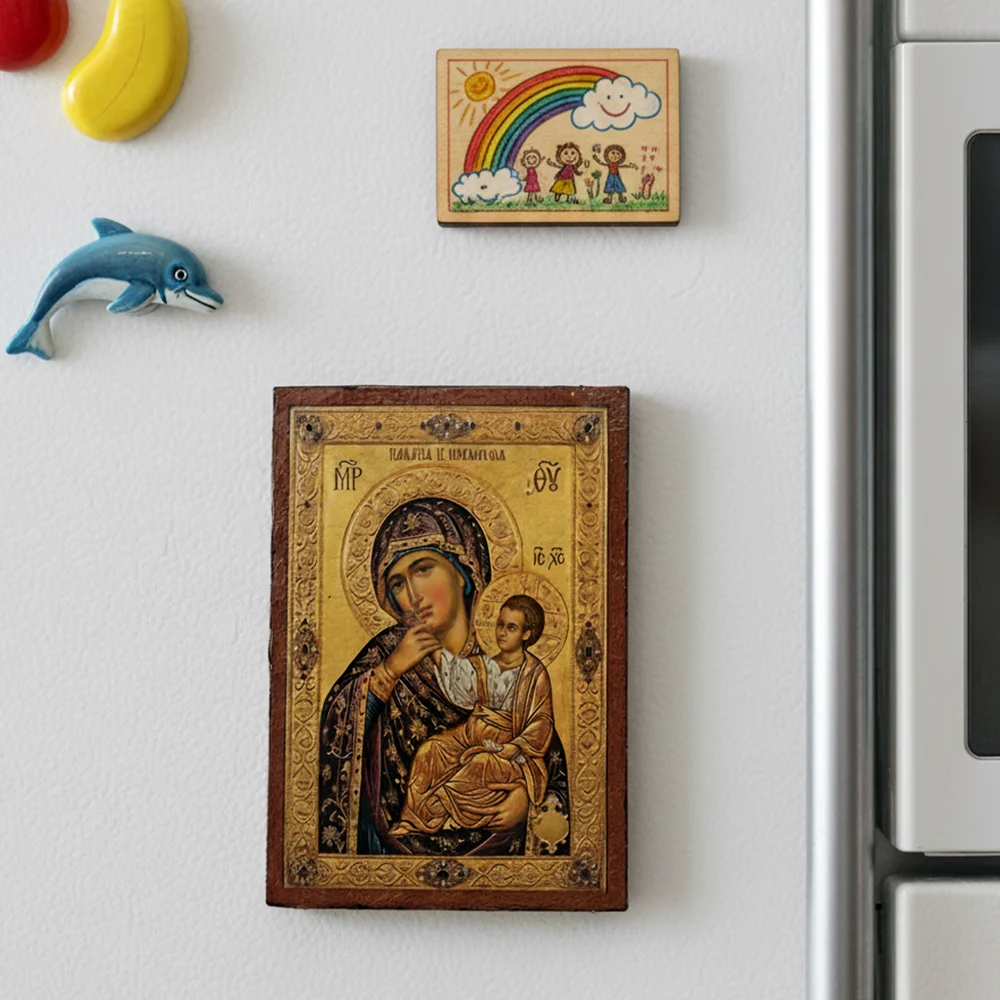 Close up of a handmade Panagia Paramythia Orthodox wooden mounted icon on a natural wood surface with magnet.