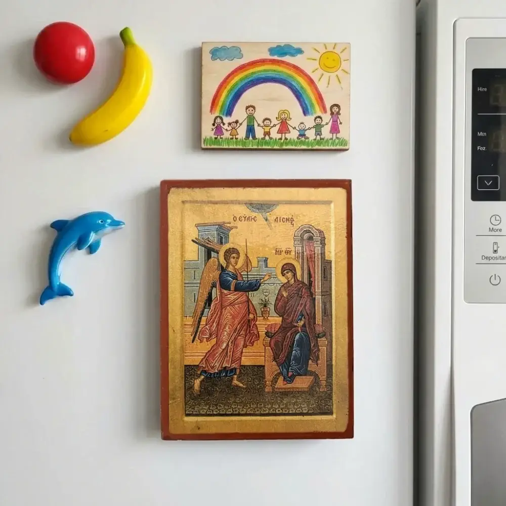 Annunciation of Theotokos Byzantine wooden-mounted icon with magnet displayed on a refrigerator